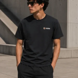 Male model wearing the KERN Essentials black T-shirt with small chest logo